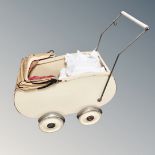 A mid century Art Deco doll's pram and a plastic doll