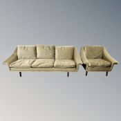 A late 20th century three seater settee with matching armchair and low chair in green fabric