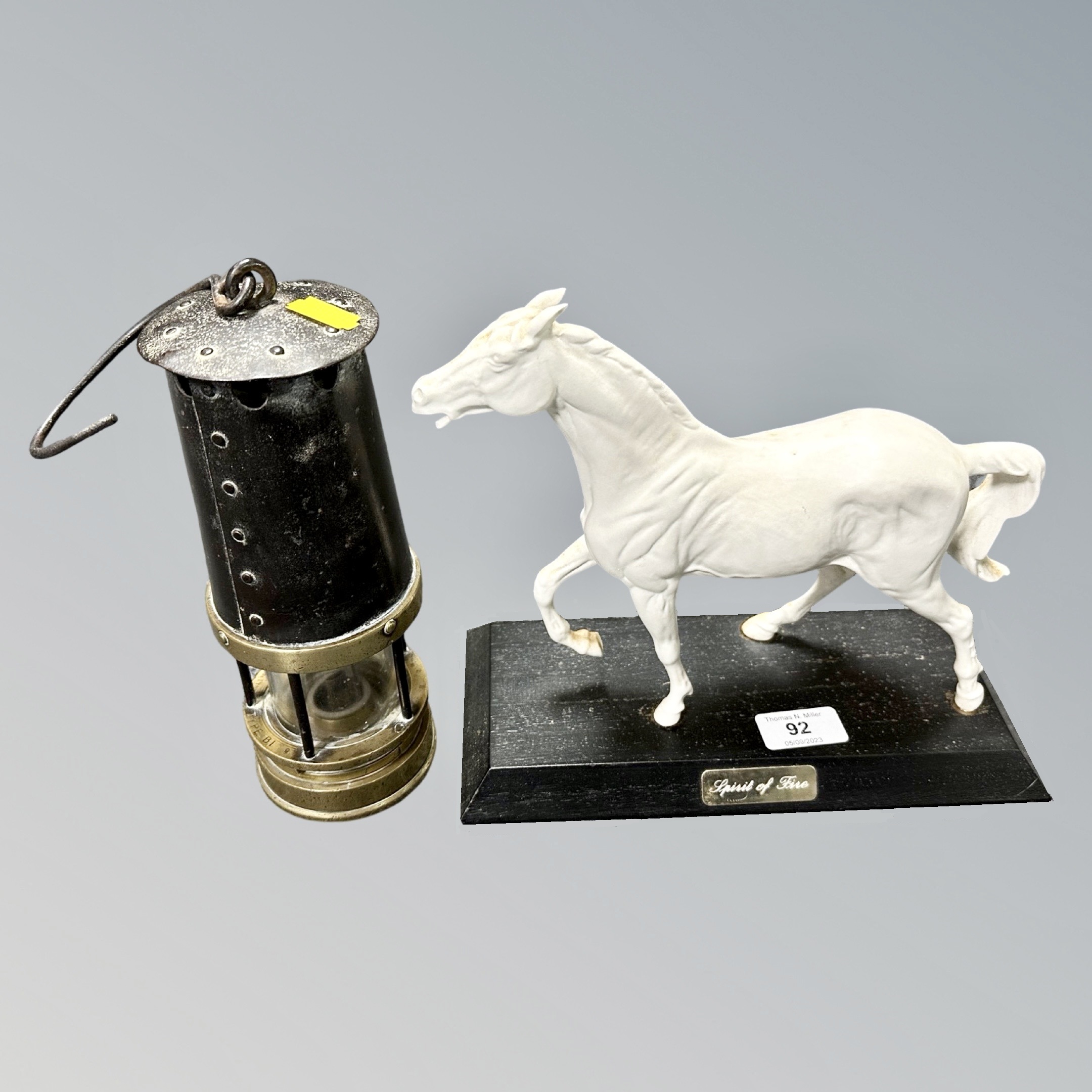 A 19th century brass and steel miner's lamp together with a figure of a horse on plinth titled