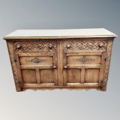 A Jaycee carved oak sideboard, 143cm long by 51cm deep by 86cm high.