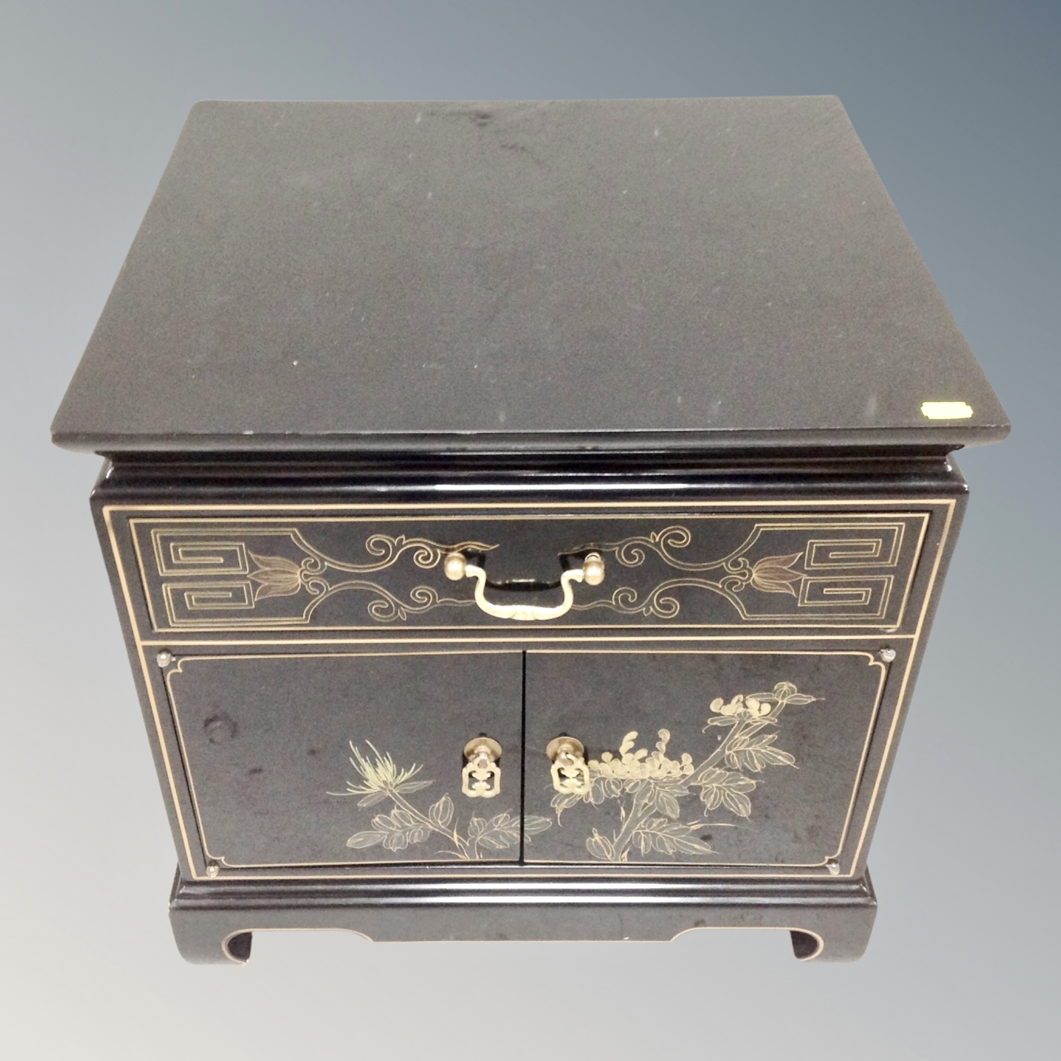 A contemporary Japanese black lacquered double door cabinet fitted a drawer