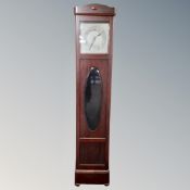 An early 20th century longcase clock with silvered dial