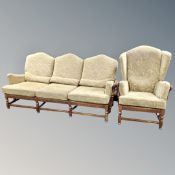 An Ercol three seater settee and wing backed armchair in golf leaf fabric