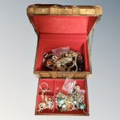 A wooden jewellery casket and contents including silver and costume jewellery, bead necklaces,