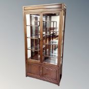A contemporary Chinese cherry wood double door display cabinet