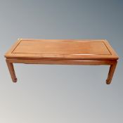 A contemporary Chinese cherry wood rectangular coffee table