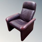 A Scandinavian Burgundy leather manual reclining armchair