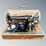 A vintage Singer electric sewing machine in case