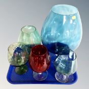 A tray of oversized coloured glass goblets