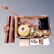 A vintage leather briefcase of sheet music, brass electric hanging oil lamp with chimney & shade,