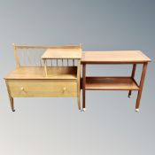 A 20th century teak two tier serving trolley and a telephone table
