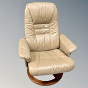 A Scandinavian swivel relaxer armchair in beige leather