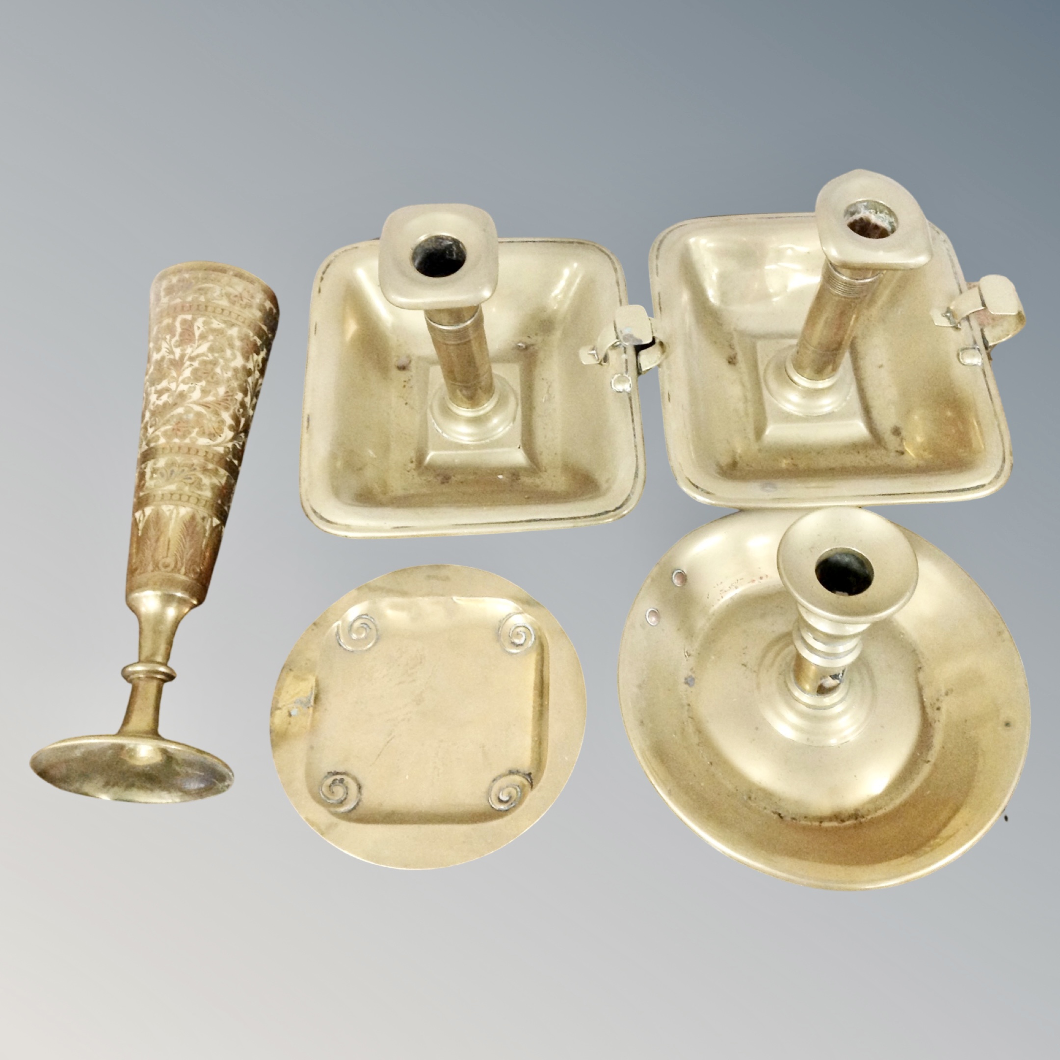 Three brass chamber sticks, Indian engraved brass vase and ashtray.