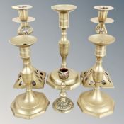 A pair of Arts & Crafts brass candlesticks and four further examples
