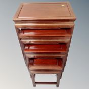 A nest of four contemporary Chinese cherry wood tables