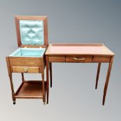 A mid century teak sewing table with a further writing table with a leather inset panel