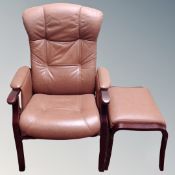A Scandinavian reclining armchair in tan leather with stool