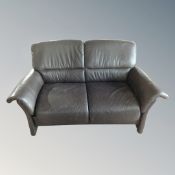 A Scandinavian brown leather two seater settee
