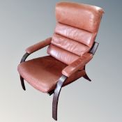 A Scandinavian bentwood high backed armchair with tan leather cushions