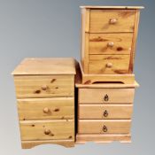 Two pine three drawer bedside chests and a further laminated chest (3)