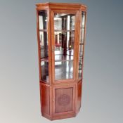 A contemporary Chinese cherry wood corner display cabinet