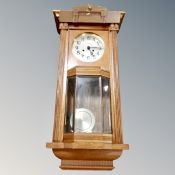 A 20th century eight day wall clock with pendulum