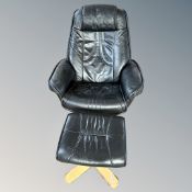 A Scandinavian swivel relaxer armchair with footstool in black leather