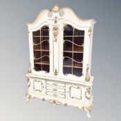 A 20th century Baroque style cream and gilt double door cabinet