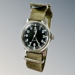 A copy of a CWC British Military issue quartz wristwatch, black dial with luminous hands,