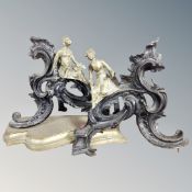 A pair of late Victorian Aesthetic period brass fire dogs, surmounted by oriental figures.