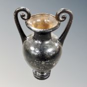 A twin-handled cast iron urn, height 44cm.