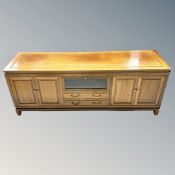 A contemporary Chinese cherry wood four door low sideboard
