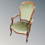 A 20th century open armchair in green dralon