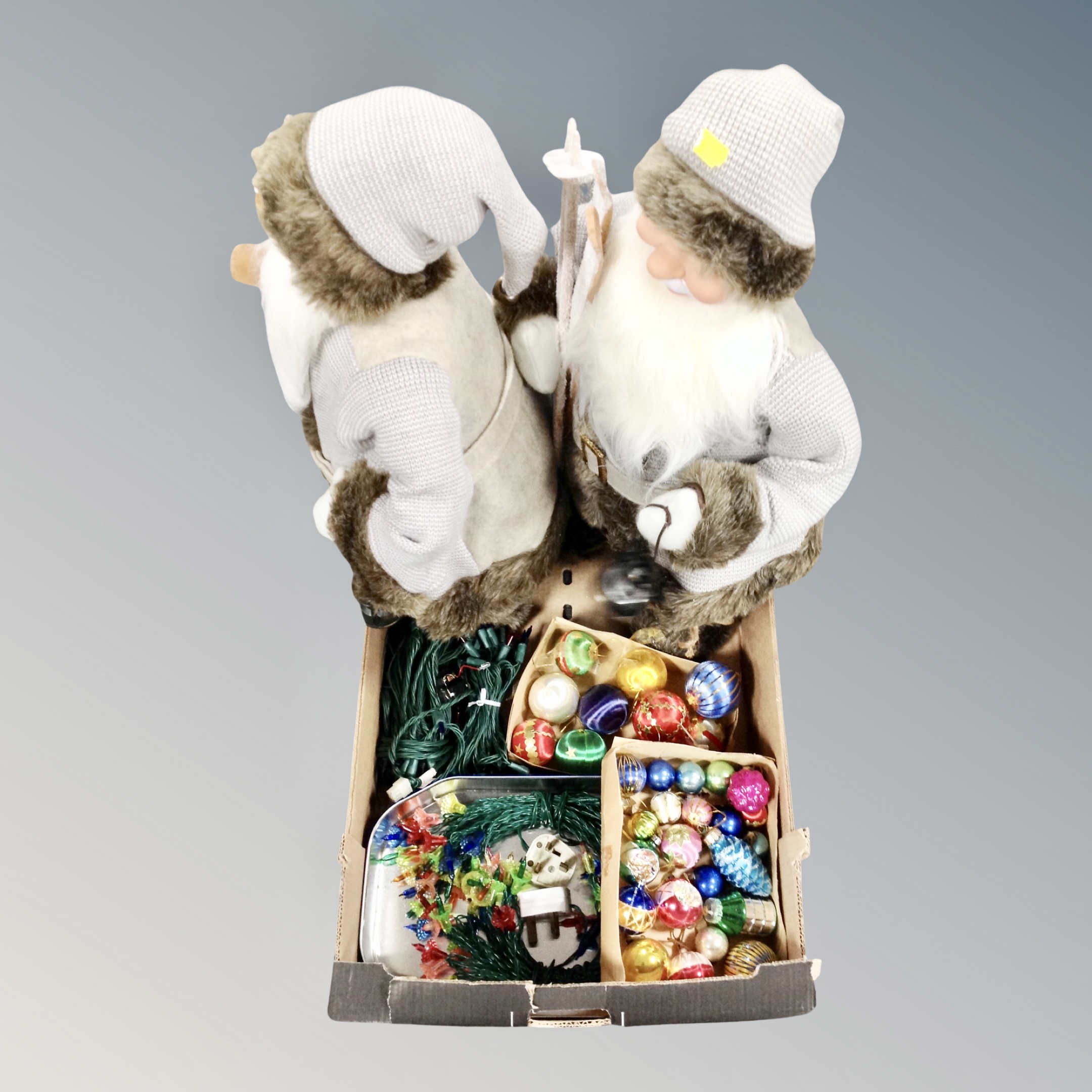 A box of two Santa figures,