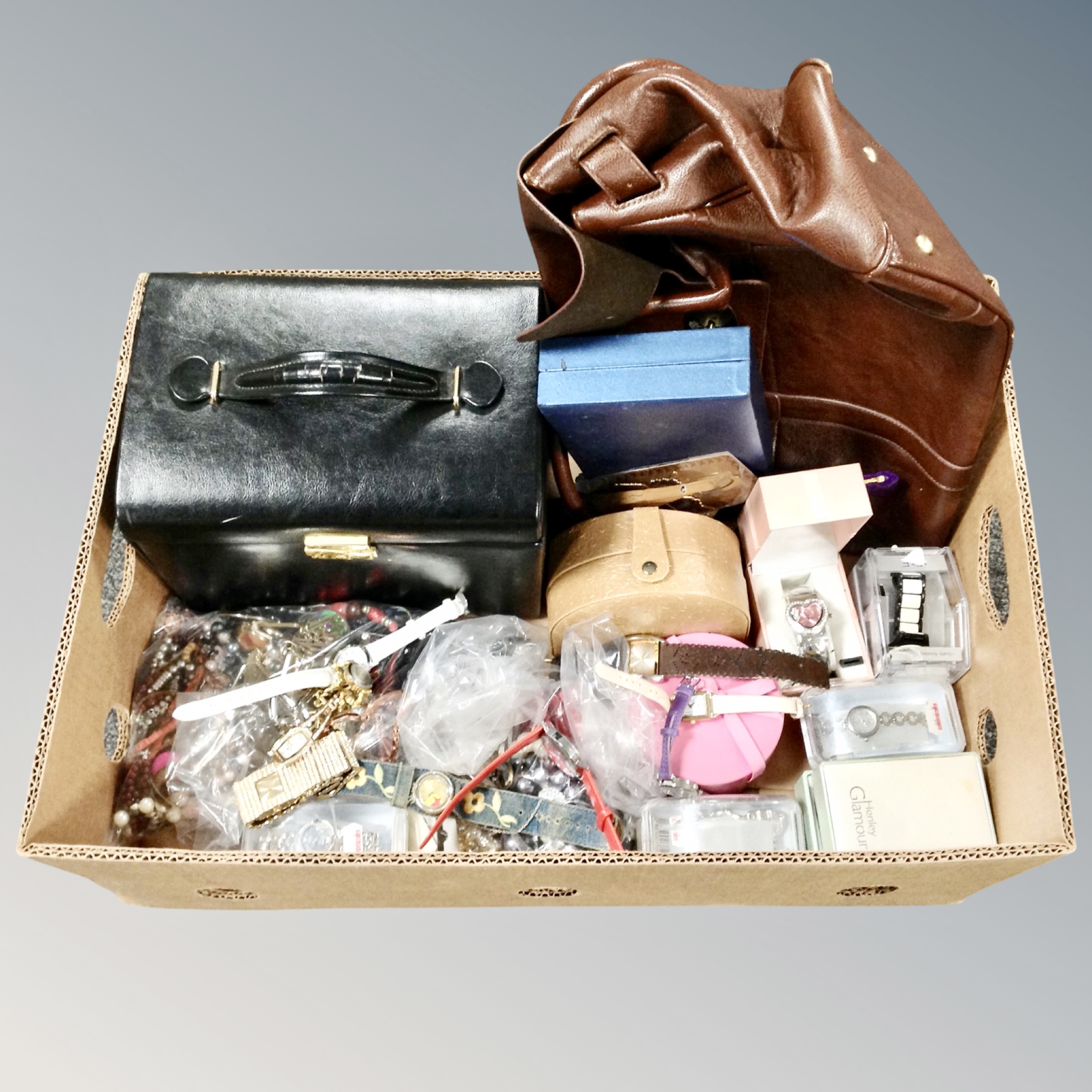 A box of faux leather jewellery box, costume jewellery and fashion watches,