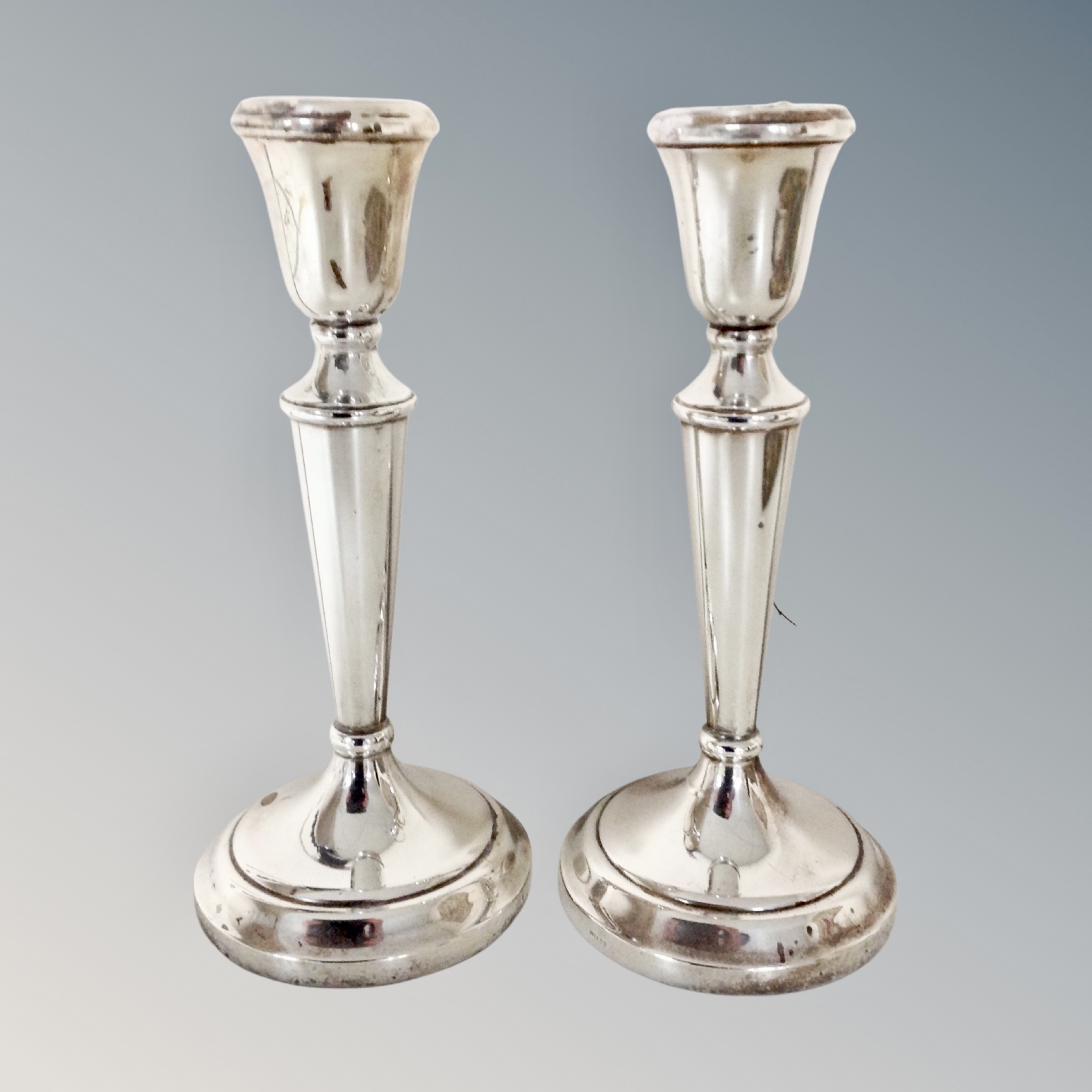 A pair of weighted silver candlesticks,