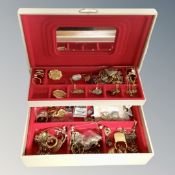 A plastic jewellery box containing dress rings,