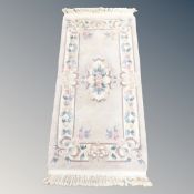 A Chinese rug on cream ground,