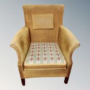 A mid 20th century armchair in gold corded fabric
