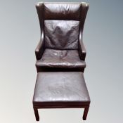 A Scandinavian 20th century wingback armchair and footstool in brown leather