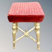 A gilt dressing table stool