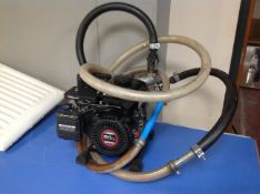 A Loncin 80 cc petrol water pump with hose
