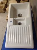 A ceramic sink with drainer