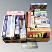 Two boxes of assorted board games and puzzles,