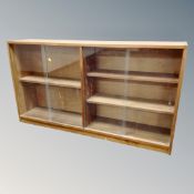 A set of mid 20th century teak sliding door bookshelves