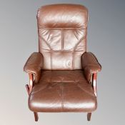 A Scandinavian wood framed manual reclining armchair in brown leather