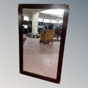 A brass-cornered rectangular mirror,