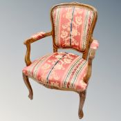 A carved beech framed open salon armchair in striped fabric
