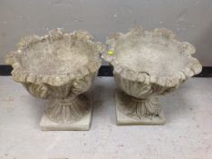 A pair of concrete classical urns on pedestals