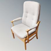 A Farstrub Mobler wood framed reclining armchair in grey button fabric